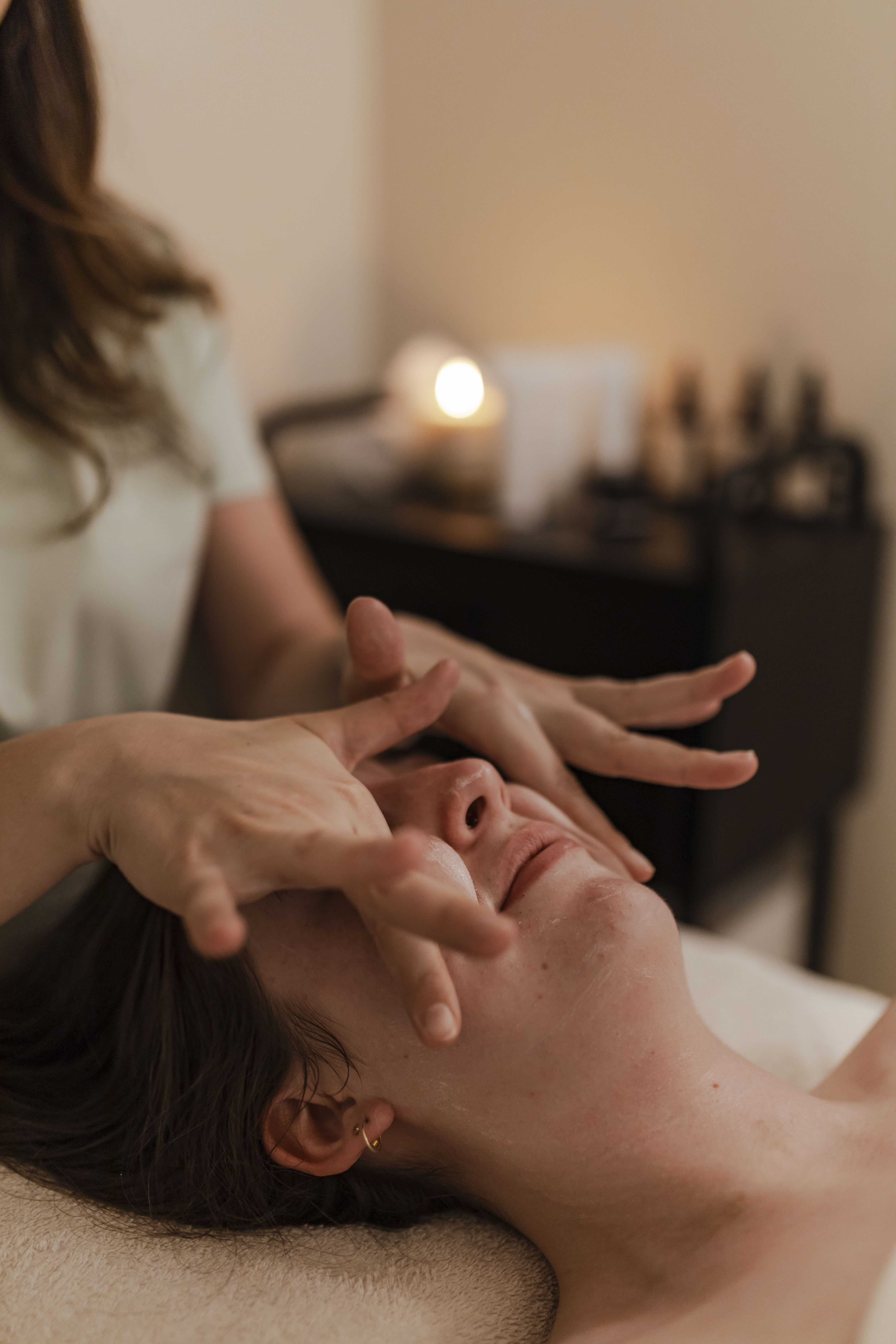 A close-up of a facial massage at The Well Spa